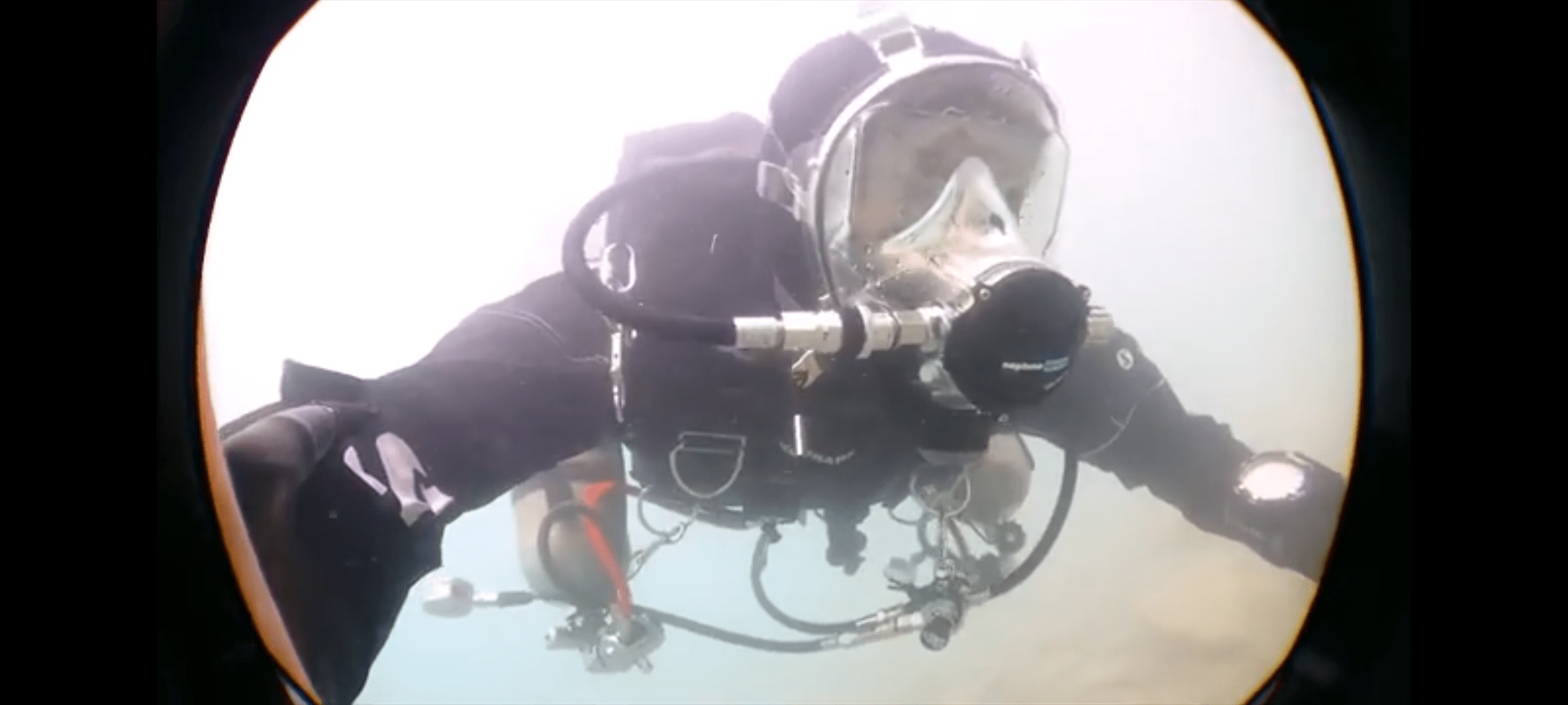 A sidemount diver in a full face masks